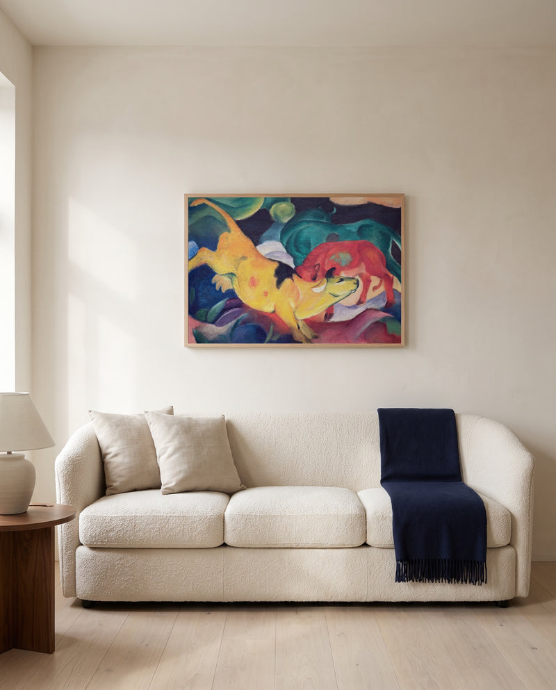 Cows, Red, Green, Yellow by Franz Marc framed in natural oak above a cream sofa in a warm living room