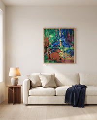 Deer in the Forest II by Franz Marc framed in natural oak above a cream sofa in a warm living room