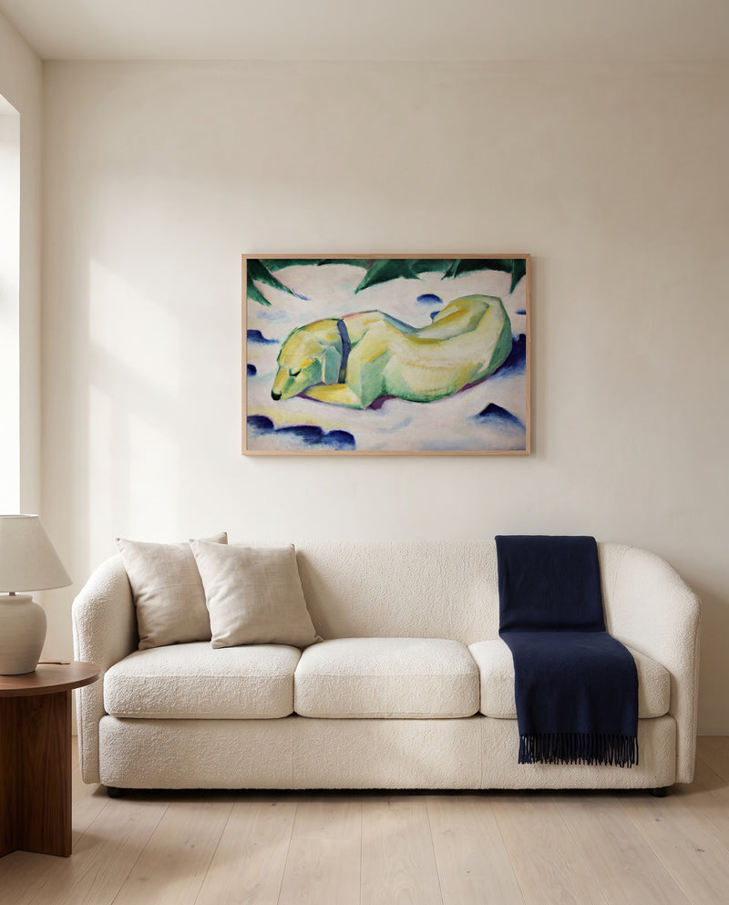 Dog Lying in the Snow by Franz Marc framed in natural oak above a cream sofa in a warm living room