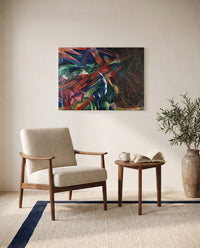 Fate of the Animals by Franz Marc as a stretched canvas above a linen lounge chair in a reading corner