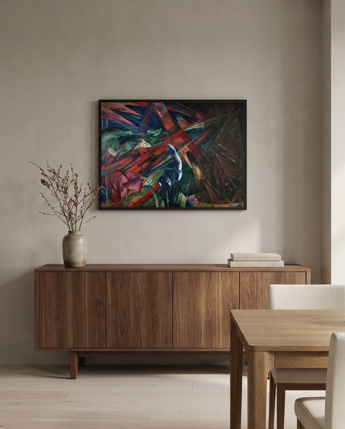 Fate of the Animals by Franz Marc in a black frame above a walnut sideboard in a dining room