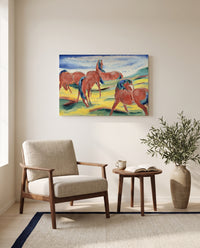 Grazing Horses III by Franz Marc as a stretched canvas above a linen lounge chair in a reading corner
