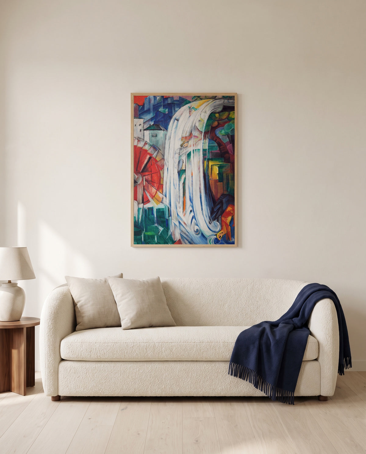 The Bewitched Mill by Franz Marc framed in natural oak above a cream sofa in a warm living room