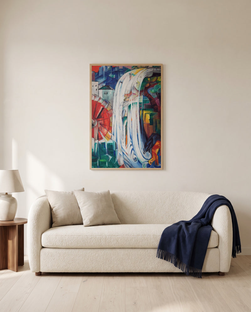 The Bewitched Mill by Franz Marc framed in natural oak above a cream sofa in a warm living room