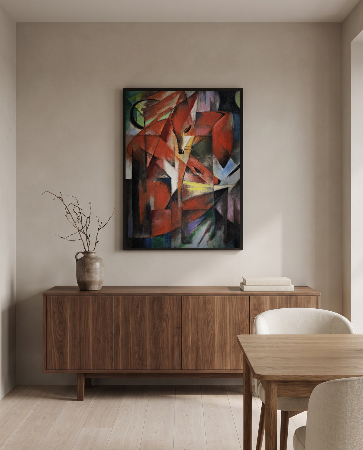 The Foxes by Franz Marc in a black frame above a walnut sideboard in a dining room