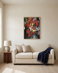 The Foxes by Franz Marc framed in natural oak above a cream sofa in a warm living room