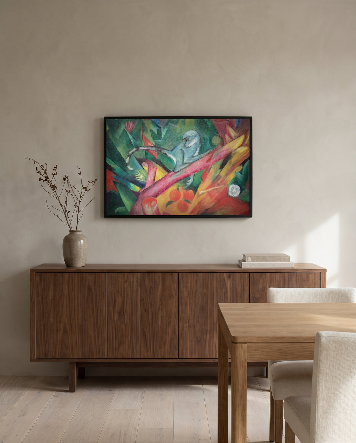 The Little Monkey by Franz Marc in a black frame above a walnut sideboard in a dining room