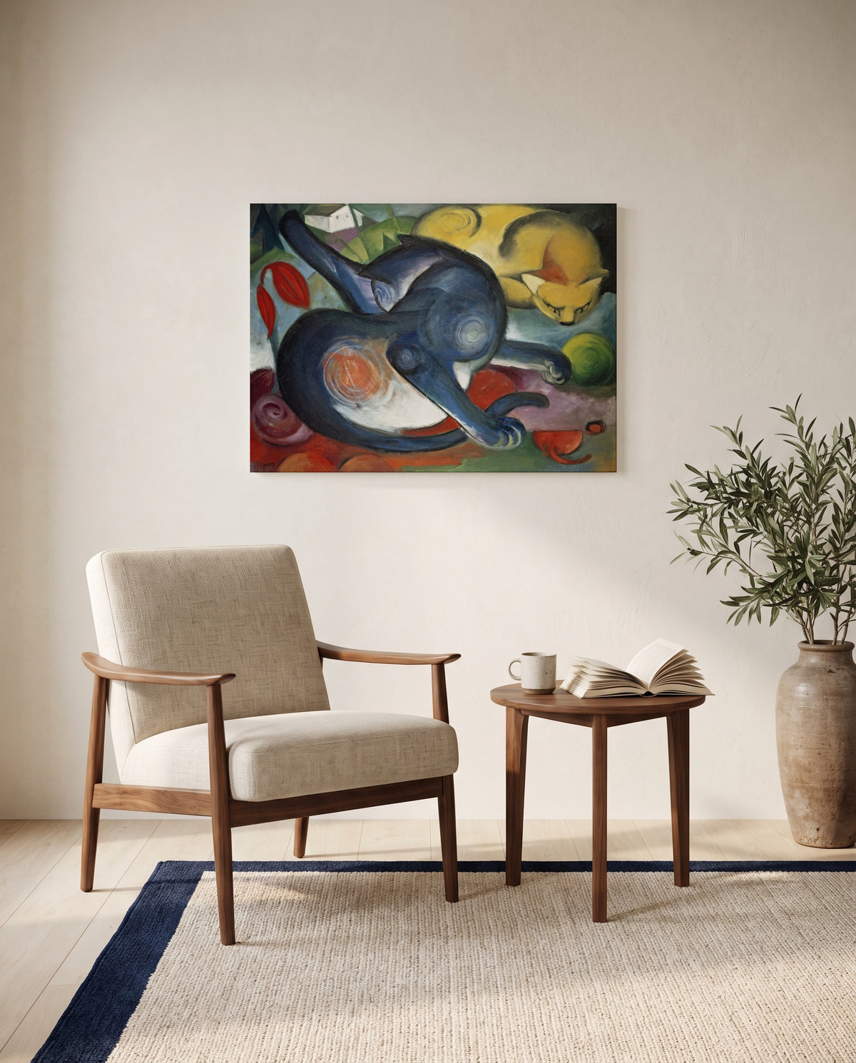 Two Cats, Blue and Yellow by Franz Marc as a stretched canvas above a linen lounge chair in a reading corner