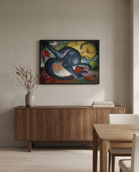 Two Cats, Blue and Yellow by Franz Marc in a black frame above a walnut sideboard in a dining room