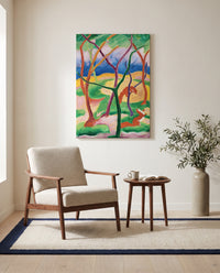 Weasels at Play by Franz Marc as a stretched canvas above a linen lounge chair in a reading corner