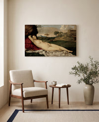 Sleeping Venus by Giorgione as a stretched canvas above a linen lounge chair in a reading corner