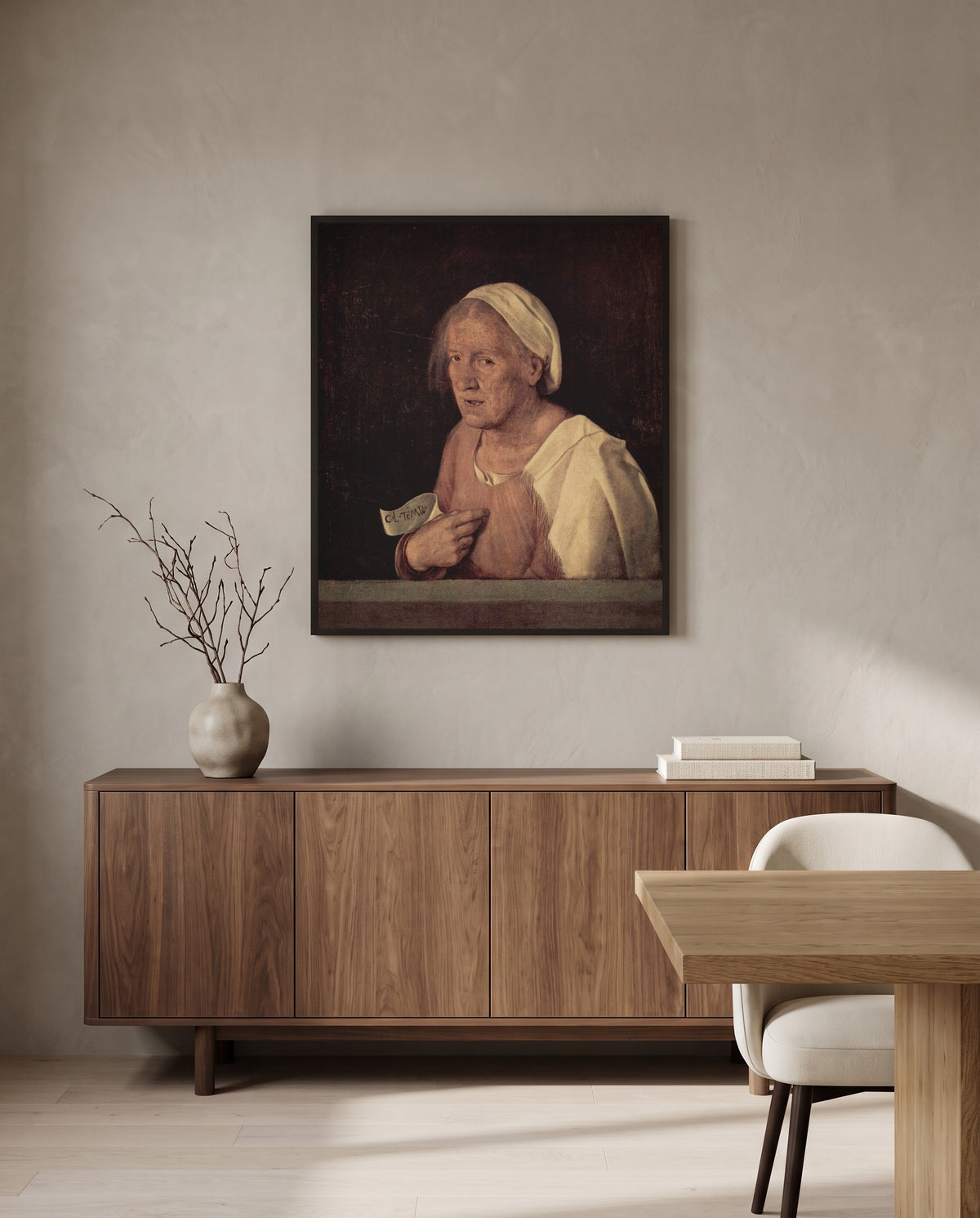 The Old Woman by Giorgione in a black frame above a walnut sideboard in a dining room