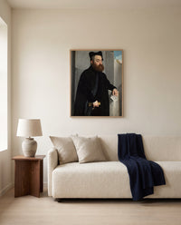 Canon Ludovico di Terzi by Giovanni Battista Moroni framed in natural oak above a cream sofa in a warm living room