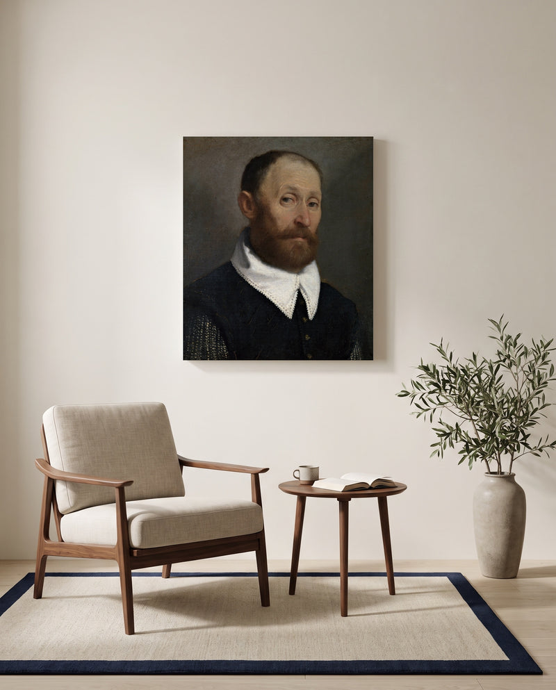 Man with Raised Eyebrows by Giovanni Battista Moroni as a stretched canvas above a linen lounge chair in a reading corner
