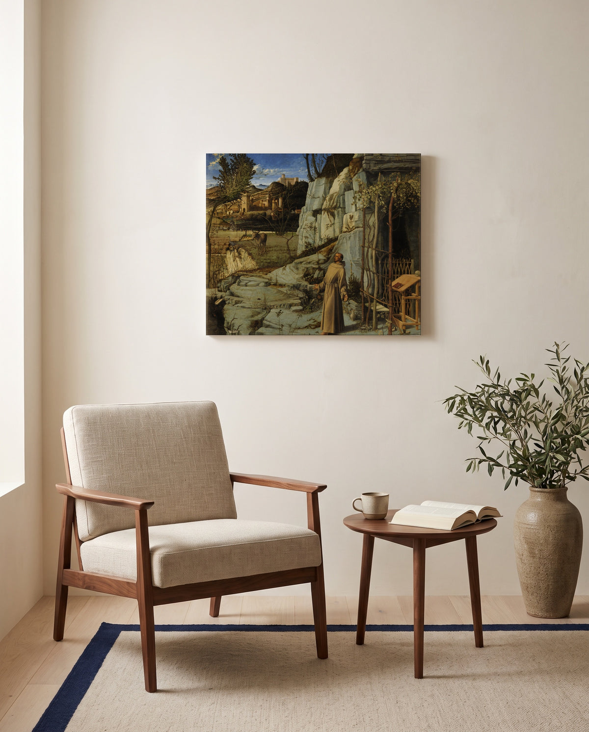 St Francis in the Desert by Giovanni Bellini as a stretched canvas above a linen lounge chair in a reading corner