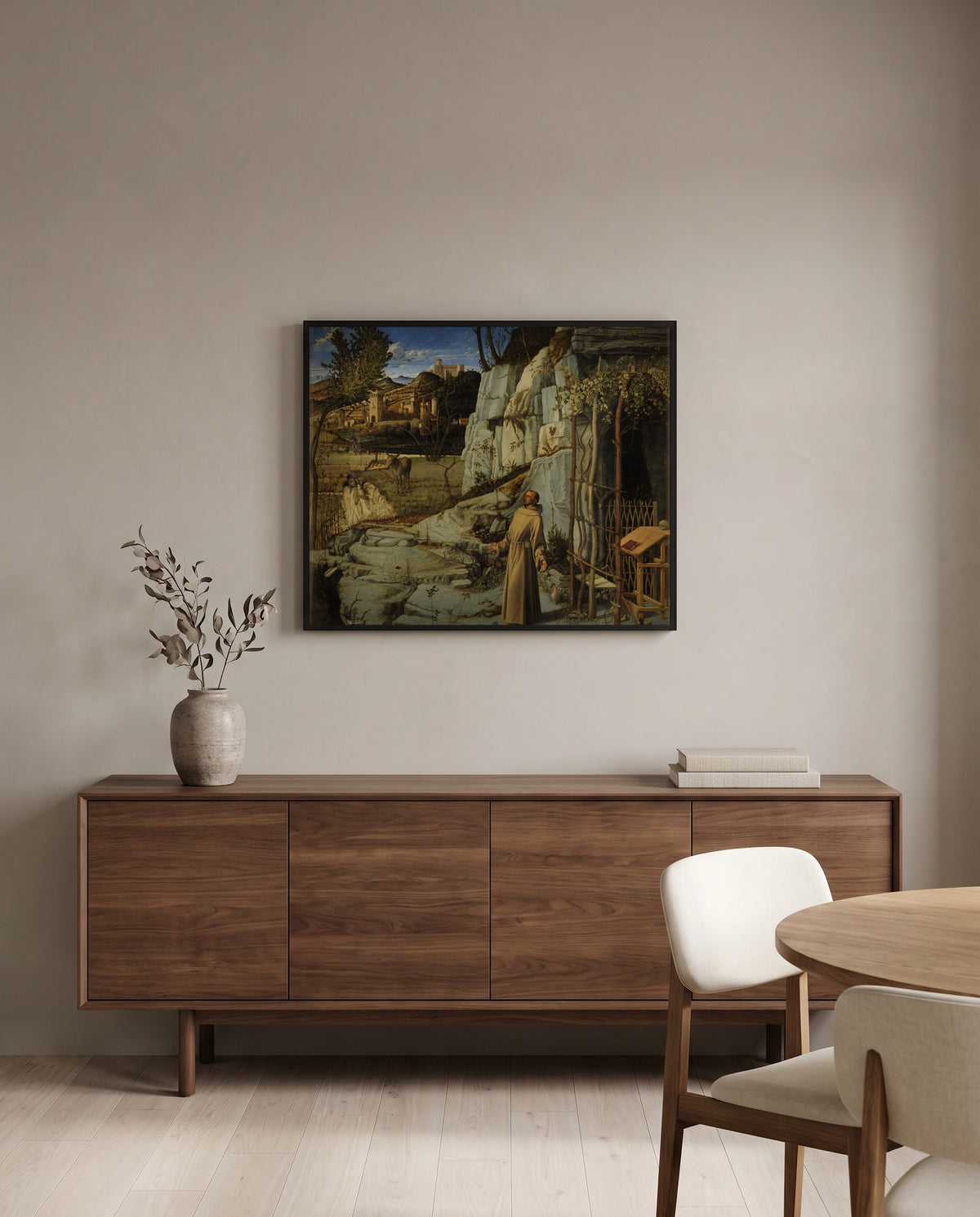 St Francis in the Desert by Giovanni Bellini in a black frame above a walnut sideboard in a dining room