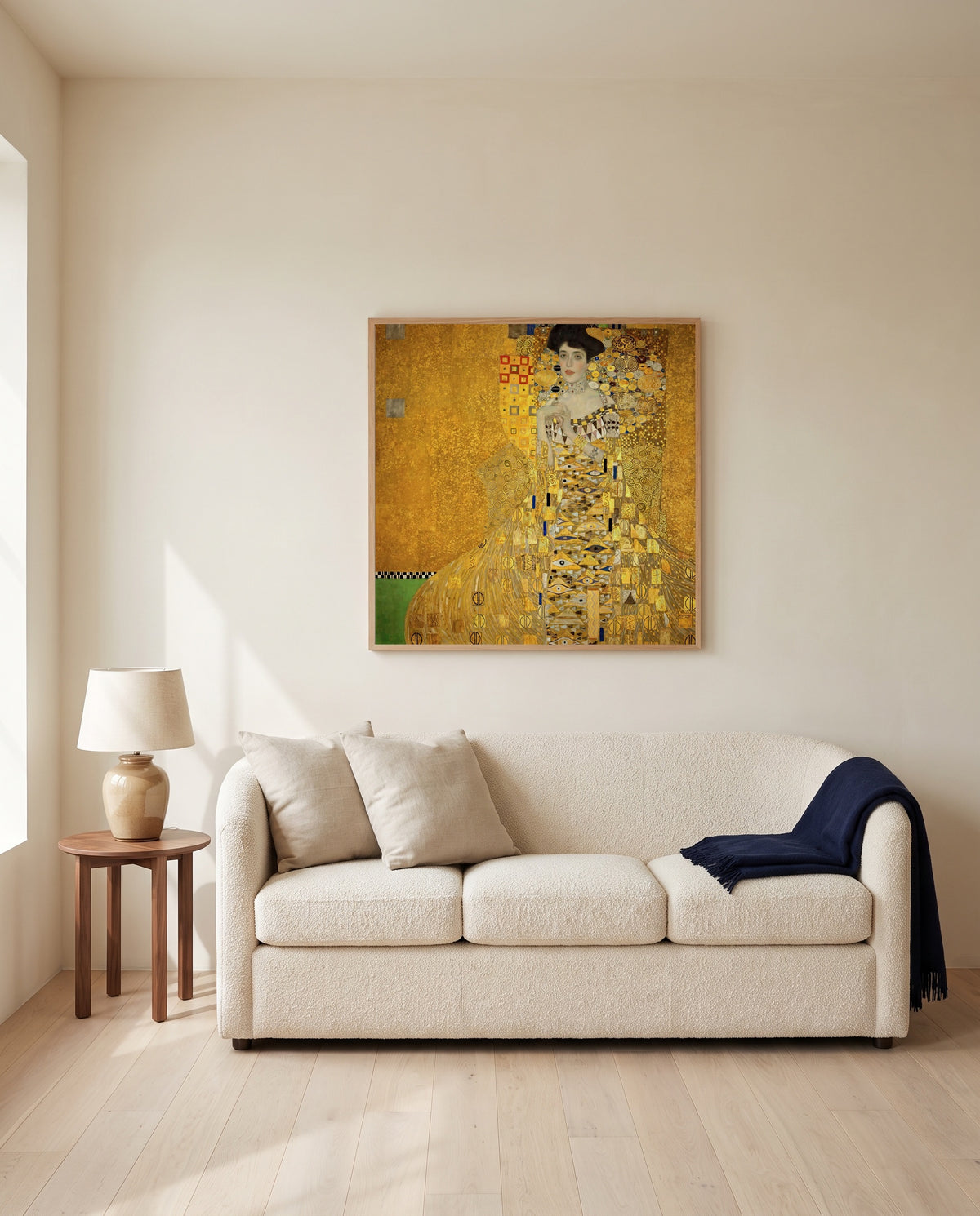 Adele Bloch-Bauer I by Gustav Klimt framed in natural oak above a cream sofa in a warm living room