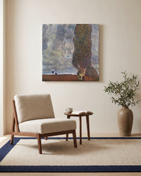 Approaching Thunderstorm by Gustav Klimt as a stretched canvas above a linen lounge chair in a reading corner