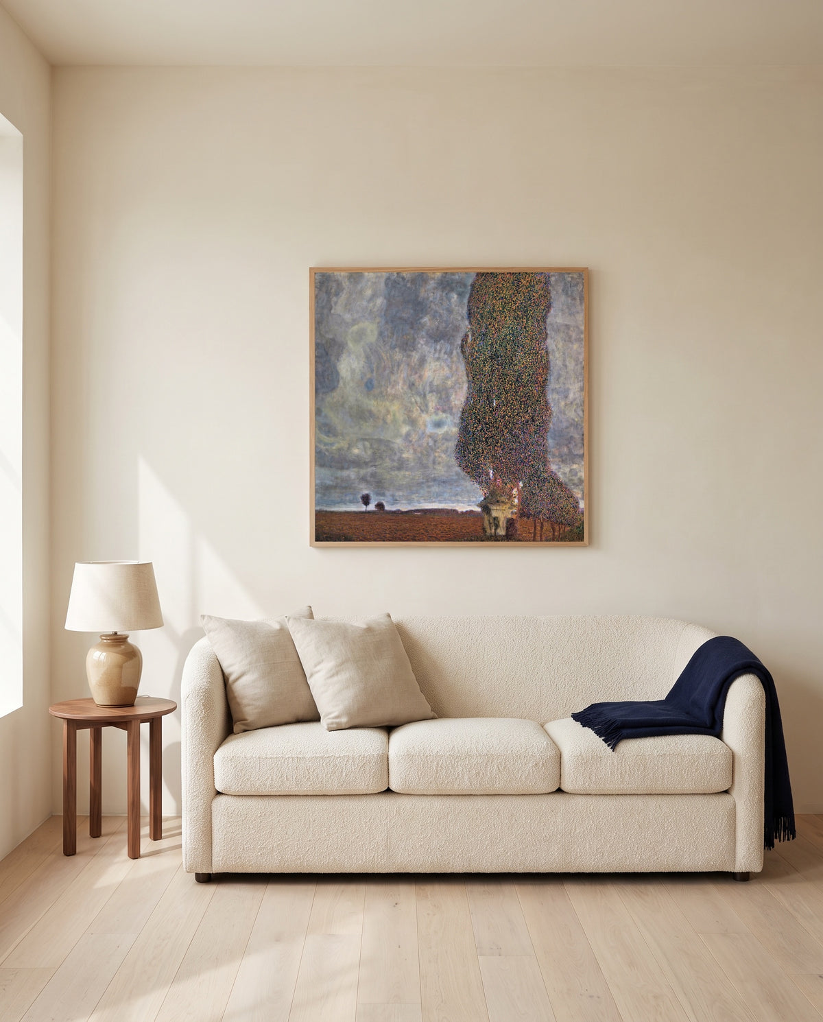 Approaching Thunderstorm by Gustav Klimt framed in natural oak above a cream sofa in a warm living room