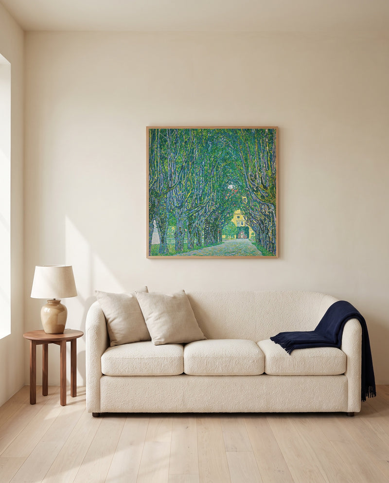 Avenue to Schloss Kammer by Gustav Klimt framed in natural oak above a cream sofa in a warm living room