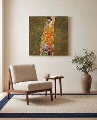 Hope II by Gustav Klimt as a stretched canvas above a linen lounge chair in a reading corner
