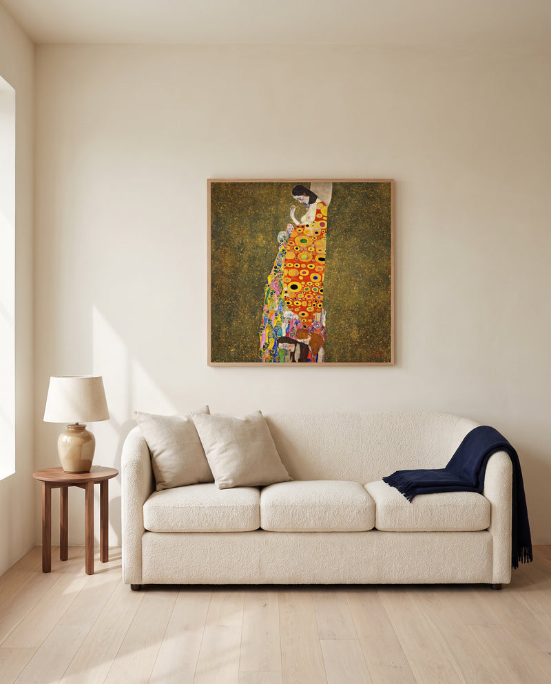 Hope II by Gustav Klimt framed in natural oak above a cream sofa in a warm living room
