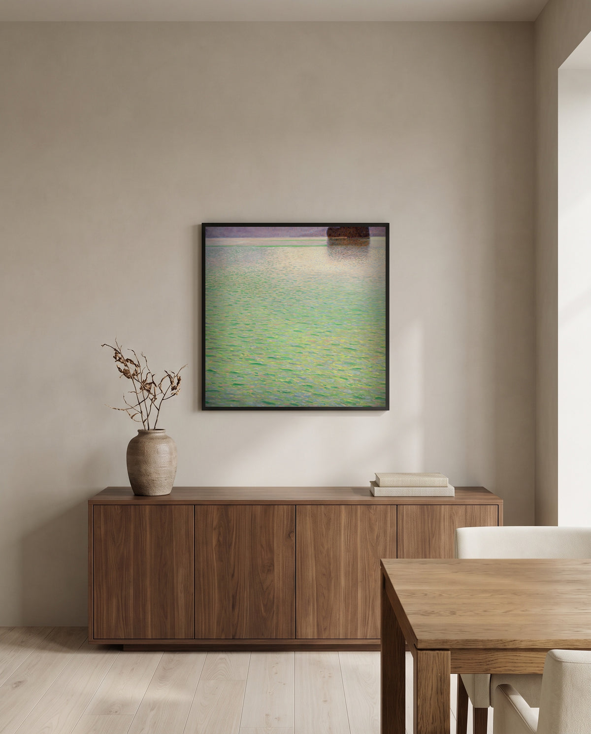 Insel im Attersee by Gustav Klimt in a black frame above a walnut sideboard in a dining room