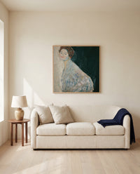 Lady in White by Gustav Klimt framed in natural oak above a cream sofa in a warm living room