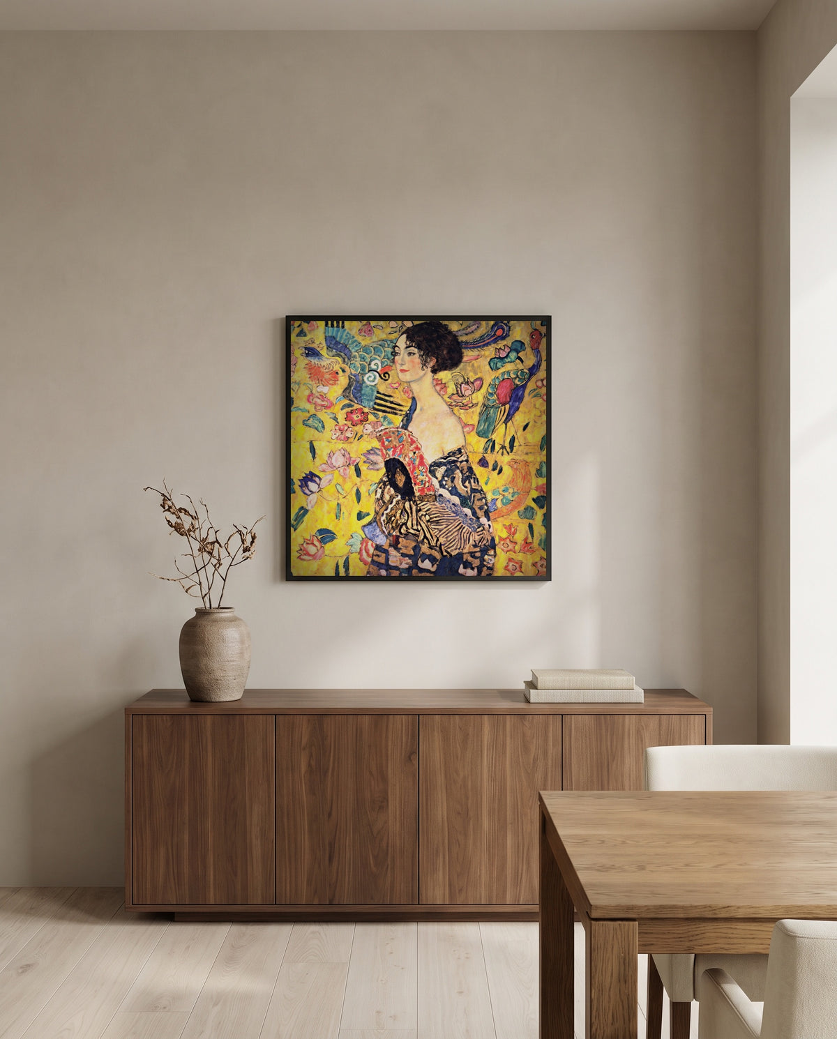 Lady with a Fan by Gustav Klimt in a black frame above a walnut sideboard in a dining room