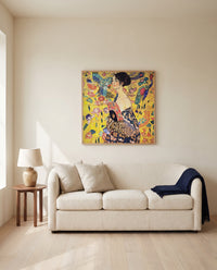 Lady with a Fan by Gustav Klimt framed in natural oak above a cream sofa in a warm living room