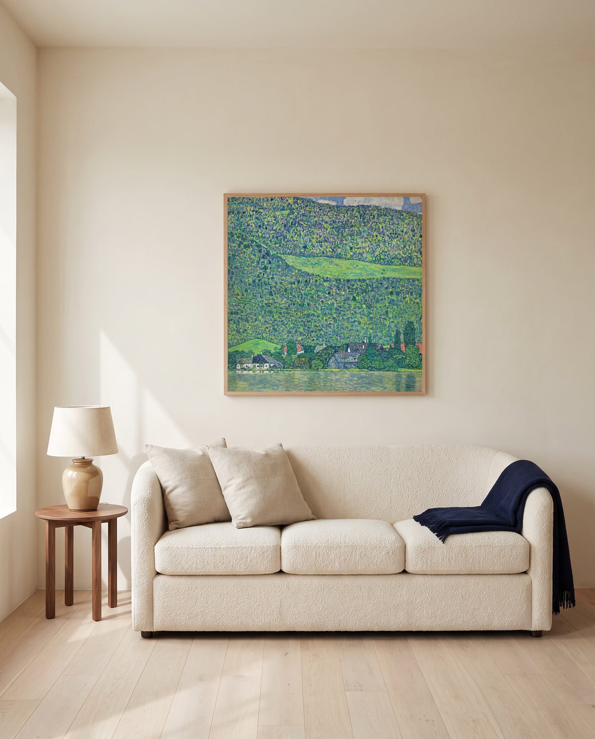 Litzlberg on the Attersee by Gustav Klimt framed in natural oak above a cream sofa in a warm living room