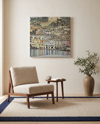 Malcesine on Lake Garda by Gustav Klimt as a stretched canvas above a linen lounge chair in a reading corner