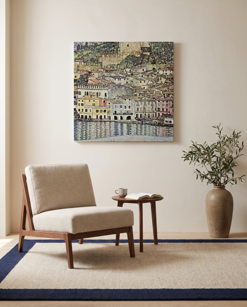 Malcesine on Lake Garda by Gustav Klimt as a stretched canvas above a linen lounge chair in a reading corner