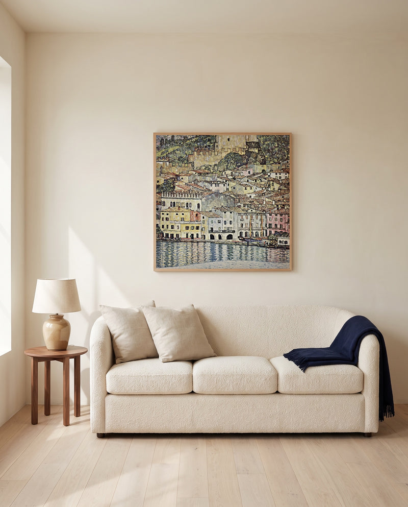 Malcesine on Lake Garda by Gustav Klimt framed in natural oak above a cream sofa in a warm living room