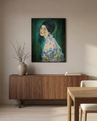 Portrait of a Lady by Gustav Klimt in a black frame above a walnut sideboard in a dining room