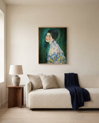 Portrait of a Lady by Gustav Klimt framed in natural oak above a cream sofa in a warm living room