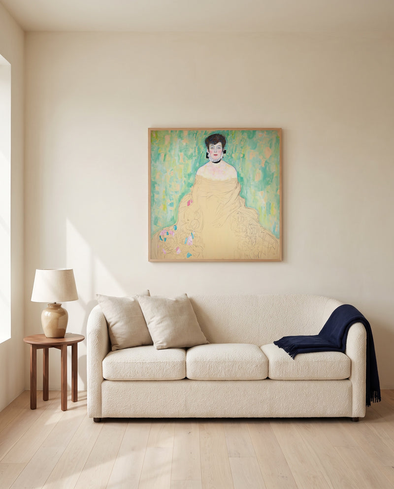 Amalie Zuckerkandl by Gustav Klimt framed in natural oak above a cream sofa in a warm living room