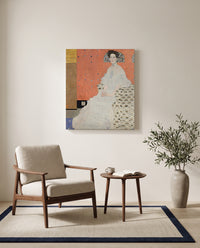 Fritza Riedler by Gustav Klimt as a stretched canvas above a linen lounge chair in a reading corner