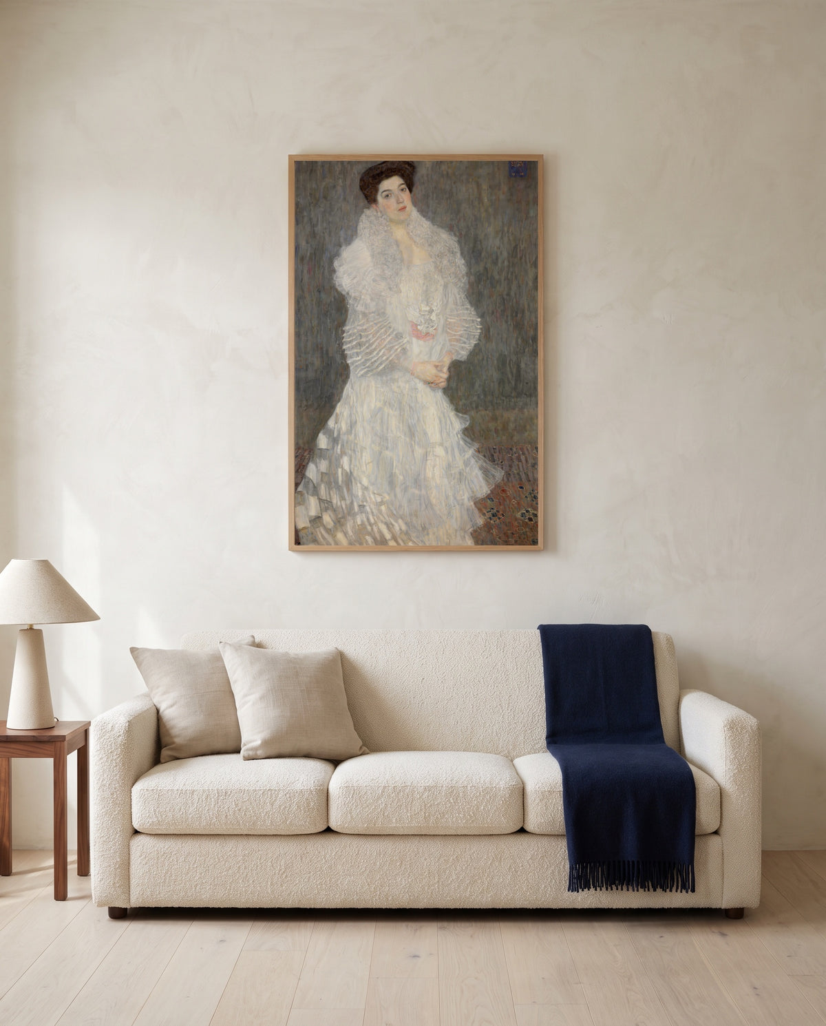 Hermine Gallia by Gustav Klimt framed in natural oak above a cream sofa in a warm living room