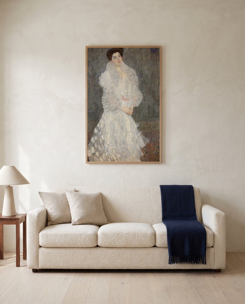 Hermine Gallia by Gustav Klimt framed in natural oak above a cream sofa in a warm living room