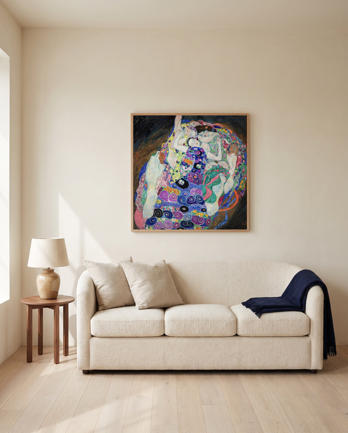 The Maiden by Gustav Klimt framed in natural oak above a cream sofa in a warm living room