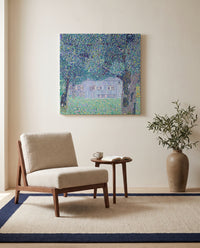 Upper Austrian Farmhouse by Gustav Klimt as a stretched canvas above a linen lounge chair in a reading corner