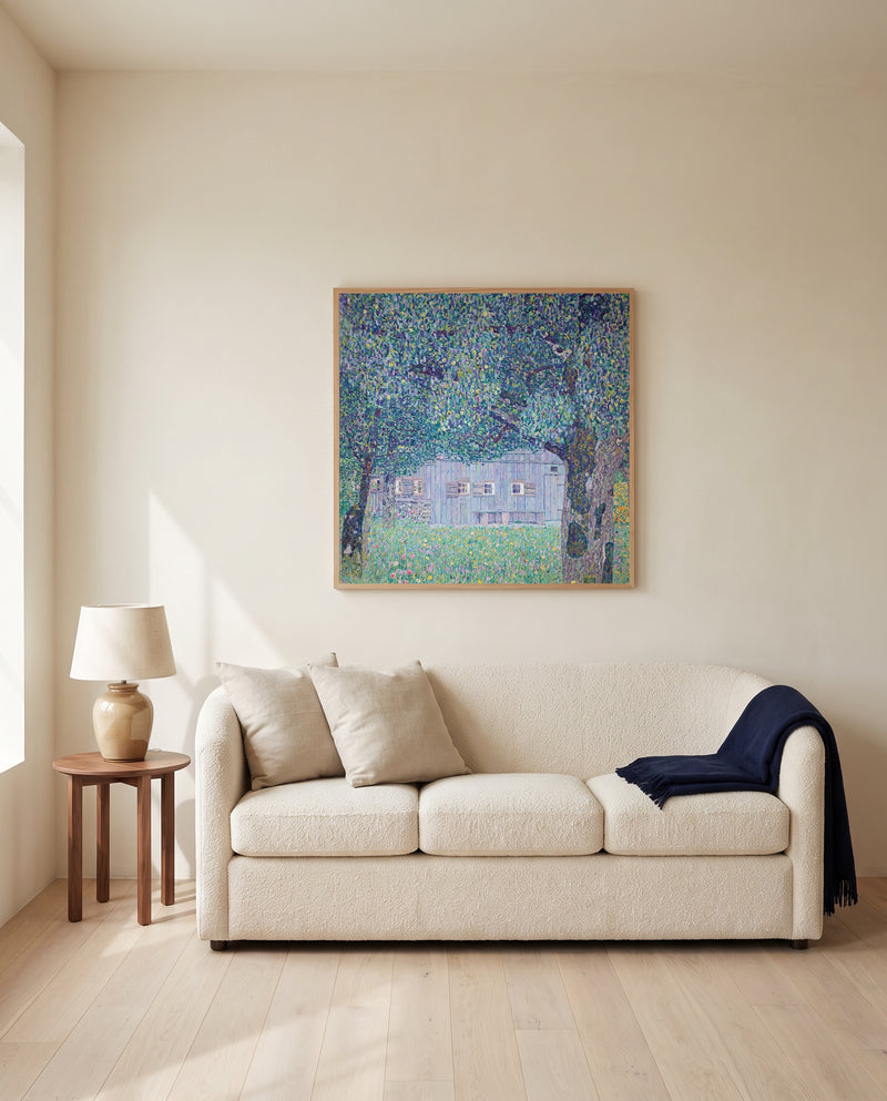 Upper Austrian Farmhouse by Gustav Klimt framed in natural oak above a cream sofa in a warm living room