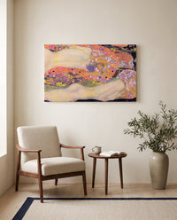 Water Serpents II by Gustav Klimt as a stretched canvas above a linen lounge chair in a reading corner