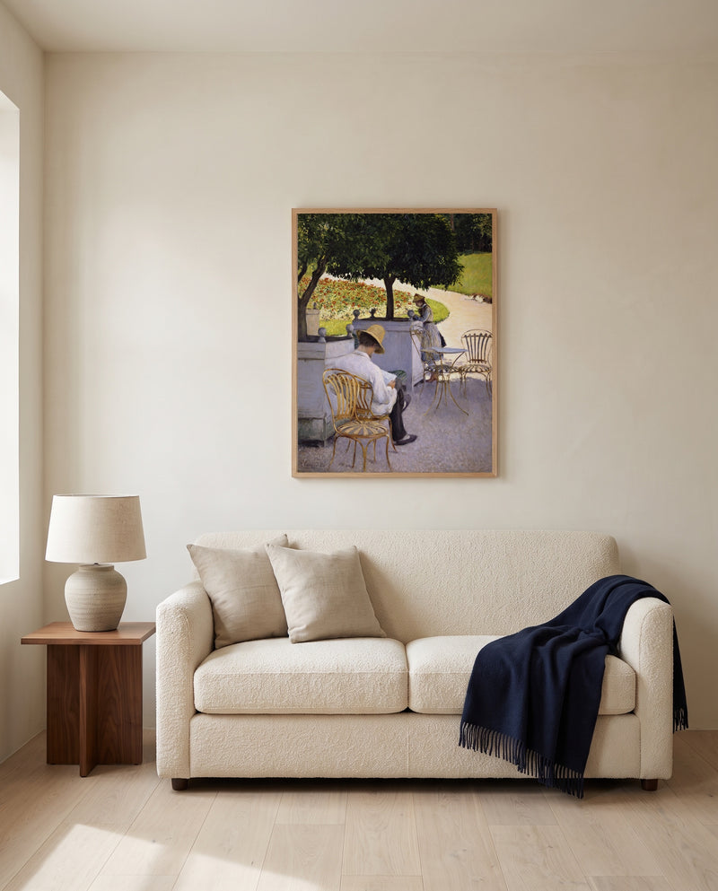 The Orange Trees by Gustave Caillebotte framed in natural oak above a cream sofa in a warm living room