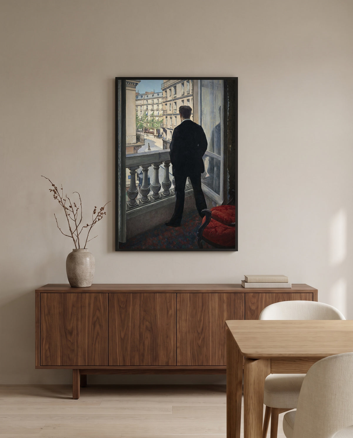 Young Man at His Window by Gustave Caillebotte in a black frame above a walnut sideboard in a dining room