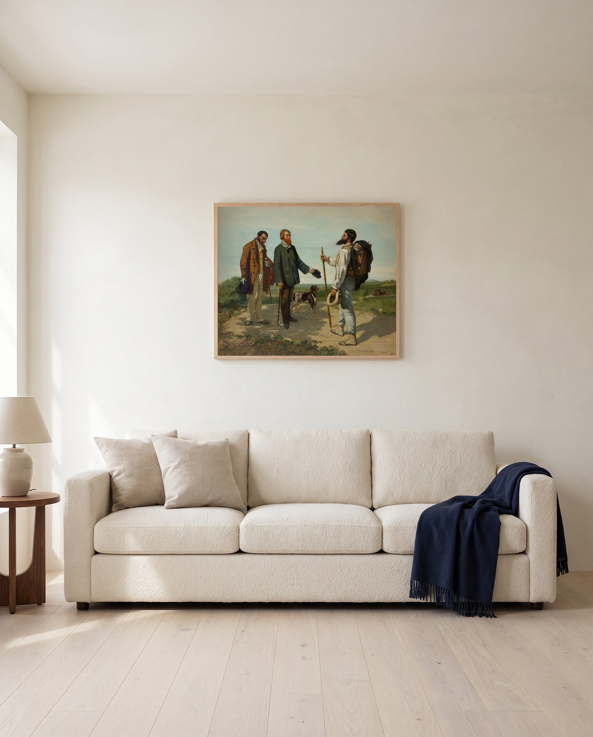 Bonjour Monsieur Courbet by Gustave Courbet framed in natural oak above a cream sofa in a warm living room