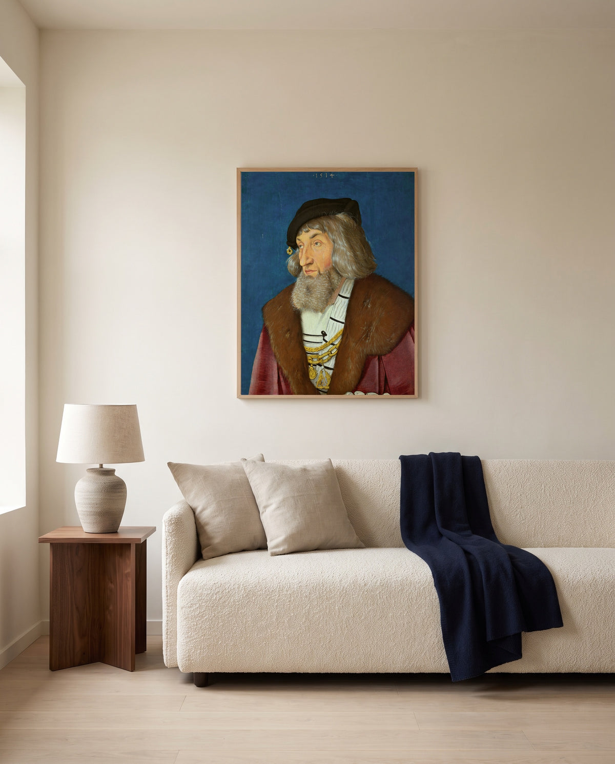 Portrait of a Man by Hans Baldung Grien framed in natural oak above a cream sofa in a warm living room