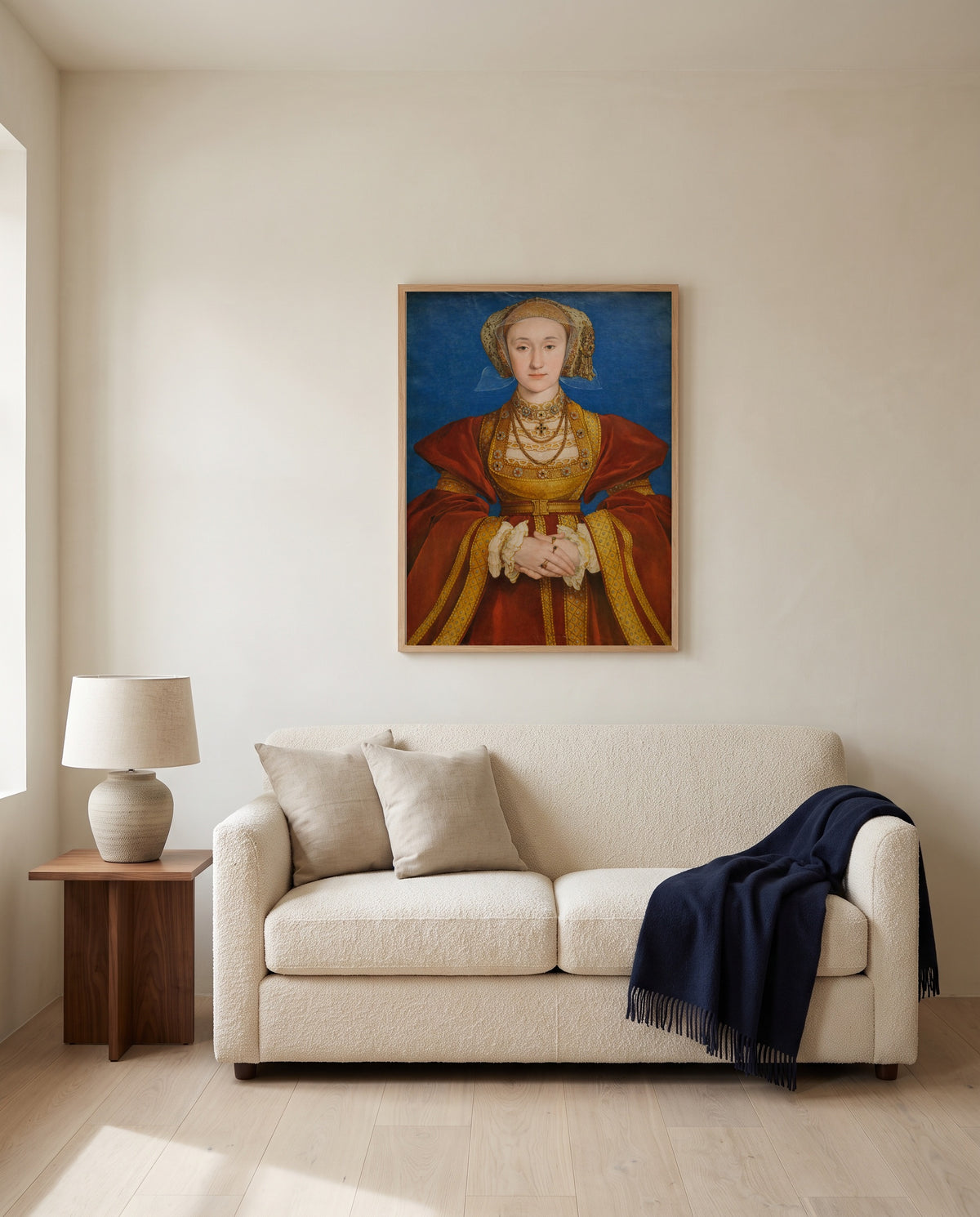 Anne of Cleves by Hans Holbein the Younger framed in natural oak above a cream sofa in a warm living room