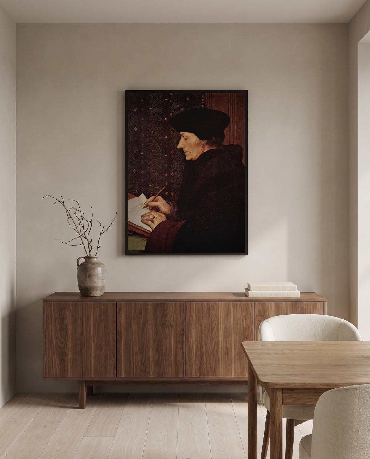 Erasmus Writing by Hans Holbein the Younger in a black frame above a walnut sideboard in a dining room